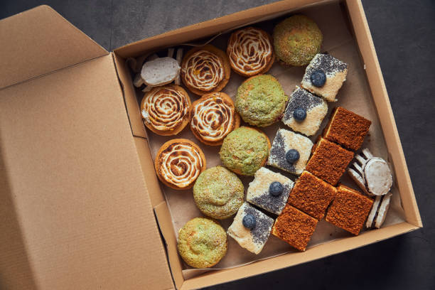 Custom Bakery Box full of delicious french seasonal spring desserts on dark background